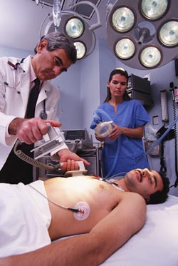 A doctor attempts to revive a heart-attack victim.