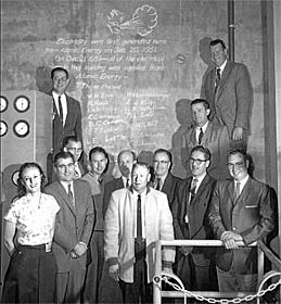 Some of those who worked on EBR-I posed in front of the sign chalked
on the wall when EBR-I produced the first electricity from atomic power